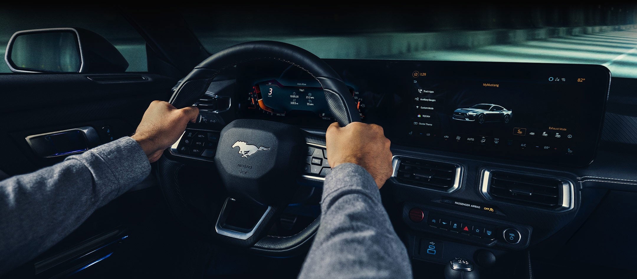 A 2024 Ford Mustang® model interior with a person driving | Crossroads Ford Ravena in Ravena NY