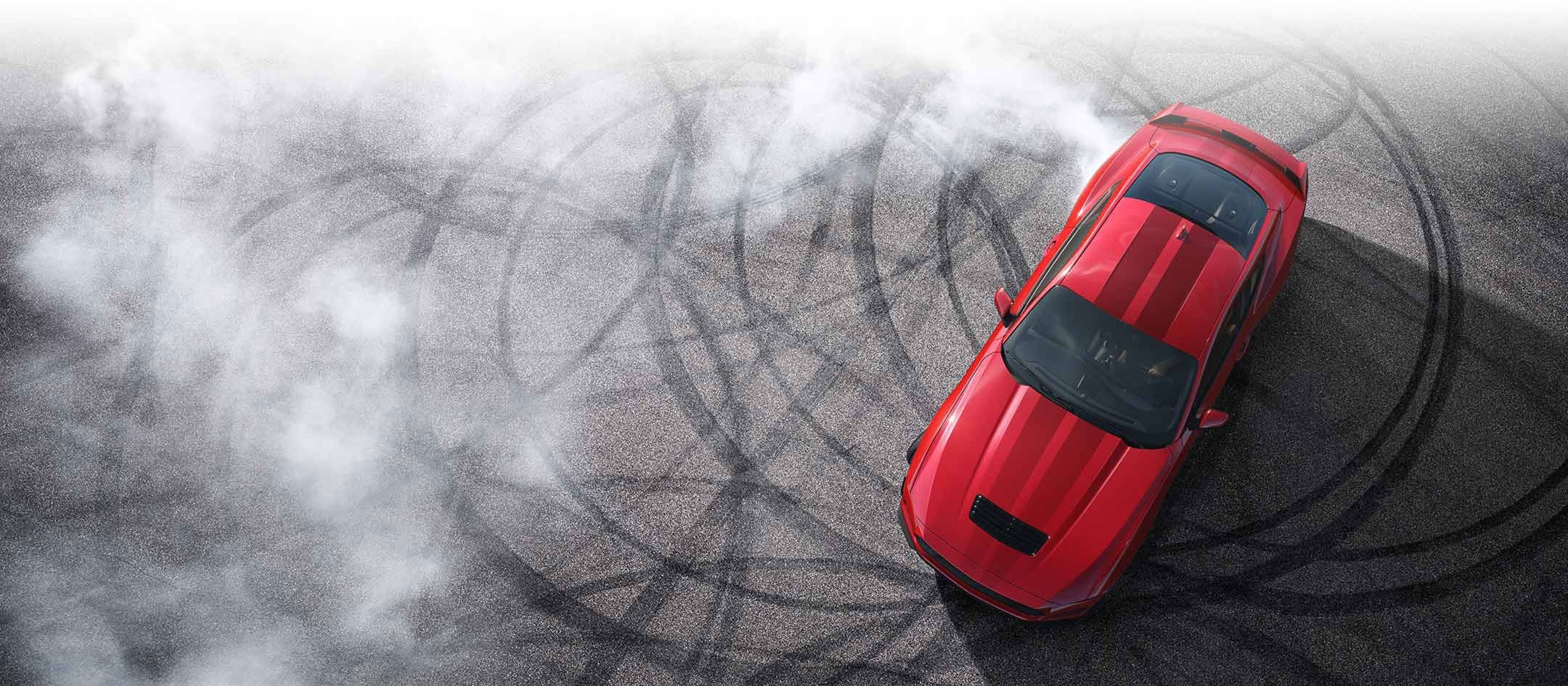 Overhead view of a 2024 Ford Mustang® model with tire tracks on pavement | Crossroads Ford Ravena in Ravena NY